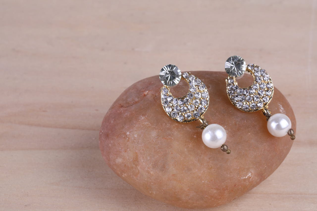 Crafting Captivating Headlines: Your awesome post title goes here Sparkling diamond and pearl earrings elegantly displayed on a stone for a stylish look.